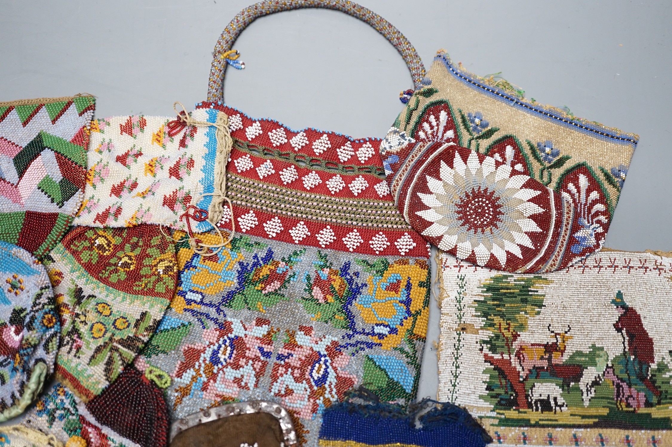 Three Victorian beadwork bags, circa 1860, largest 17cm high, and a collection of eleven smaller reticules and purses